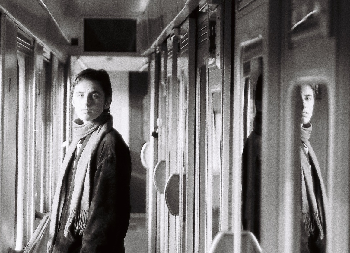 Rocky Lorelei - black and white analogue photograph with reflections in what looks like a train carriage window